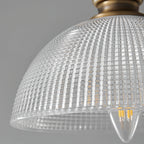 Close view of the ribbed glass dome on this Clérachic pendant, showing a candle-shaped filament bulb inside.