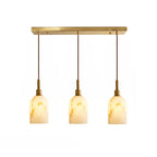 Three-light bar version of this Clérachic pendant light, with three veined cylinder shades hung from a brass rectangular canopy.