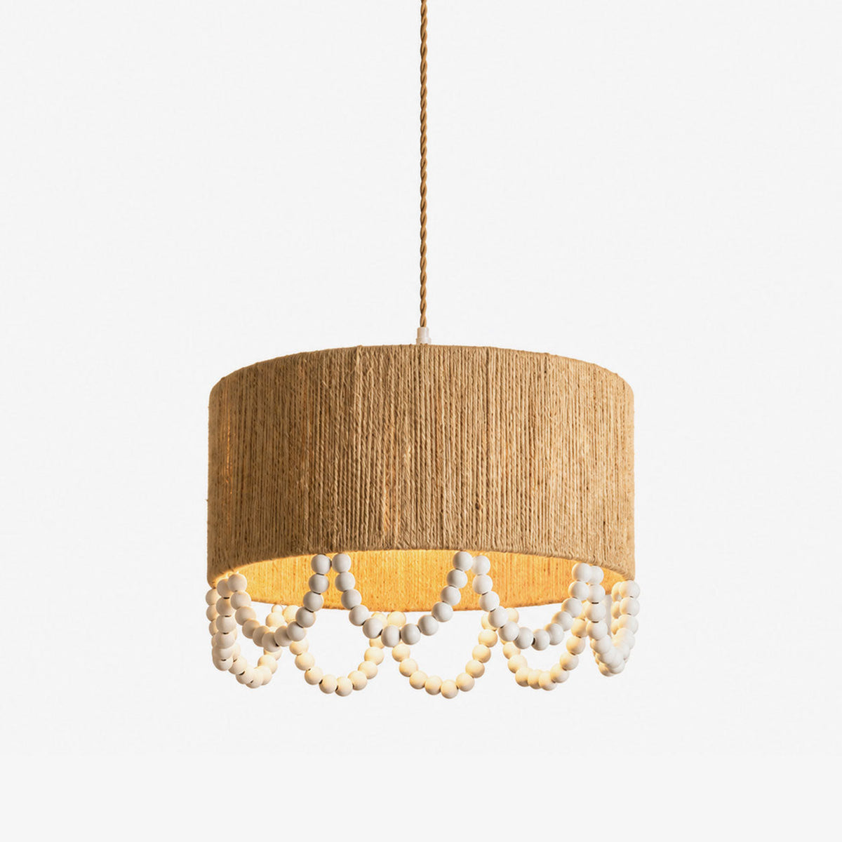 Studio view of this Clérachic pendant, a hemp rope drum shade with a scalloped wood-bead fringe beneath.