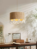 Warm light spills from this Clérachic pendant onto a styled sideboard corner with glass jars and framed prints.
