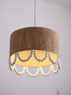 A darker brown version of this Clérachic pendant, its rope shade and grey beads shown on a plain backdrop.