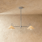 Clérachic pendant light in chrome, its two cone shades hanging from a slim rod against a plaster ceiling.