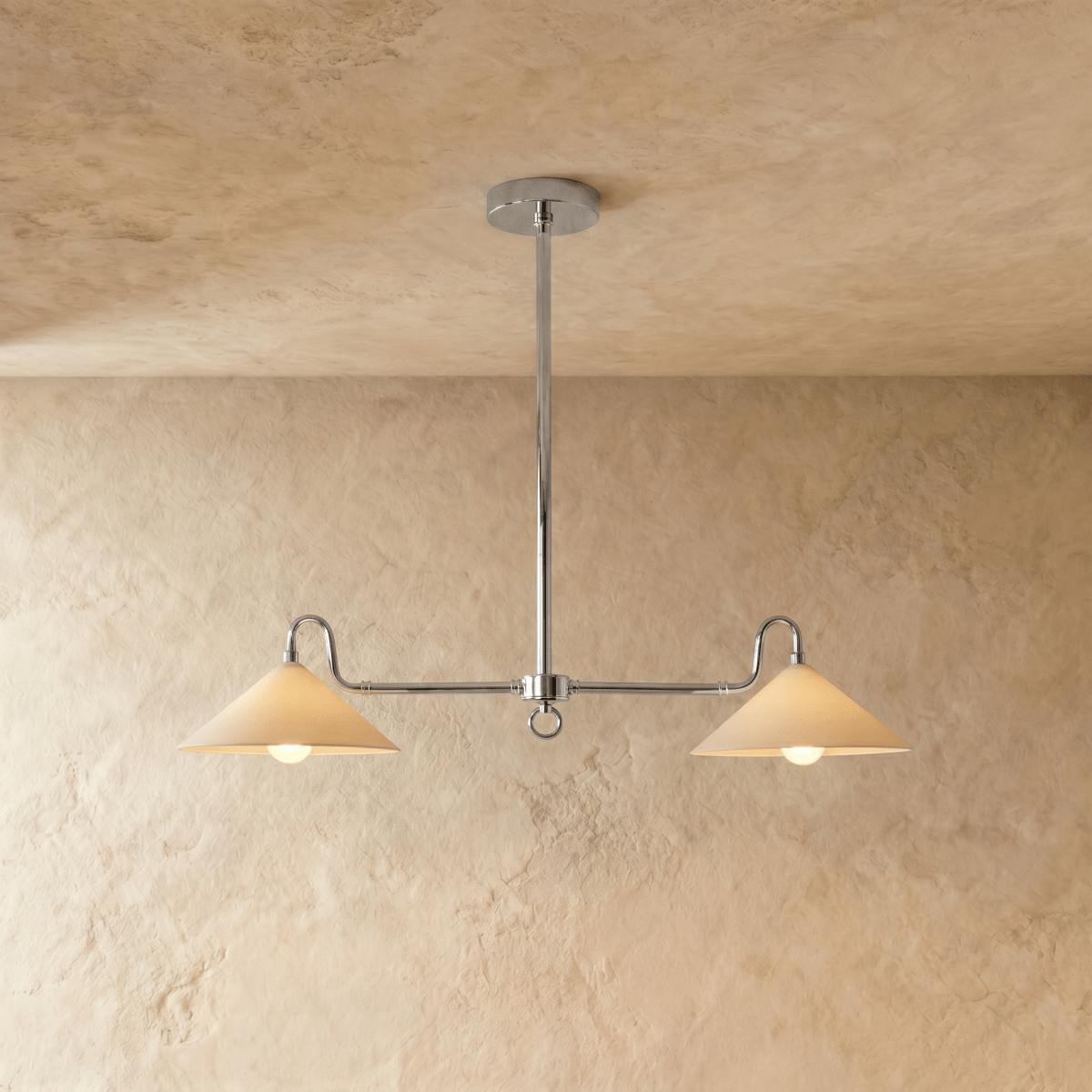 Clérachic pendant light in chrome, its two cone shades hanging from a slim rod against a plaster ceiling.