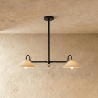 Clérachic pendant light in matte black, twin cone shades suspended from a single ceiling rod.