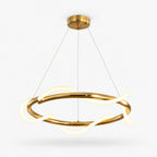 Round brass-finish pendant from Clérachic with a glowing silicone wave looping around a slim metal ring, on a plain white backdrop.