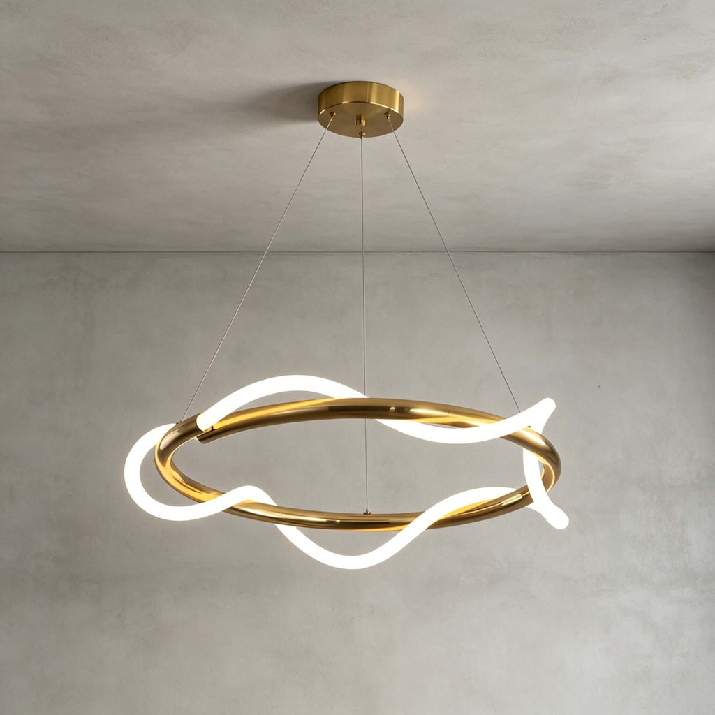 Wider wave on this Clérachic ring pendant, with the glowing silicone ribbon looping across a brass ring on a plain grey wall.