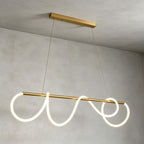 Angled view of the linear Clérachic pendant, its glowing silicone ribbon looping at each end of the brass bar on two fine cables.