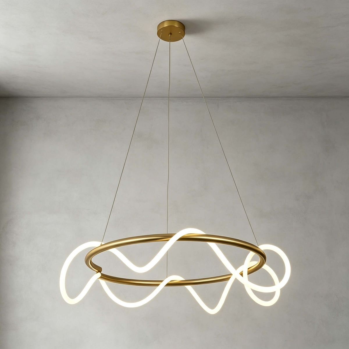 Round brass ring pendant from Clérachic, a lit silicone ribbon weaving through the ring, hung from a round brass canopy.