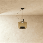 Clérachic mid-size pendant in amber glass, softly squared shade on a black arm and cord, lit against plaster.