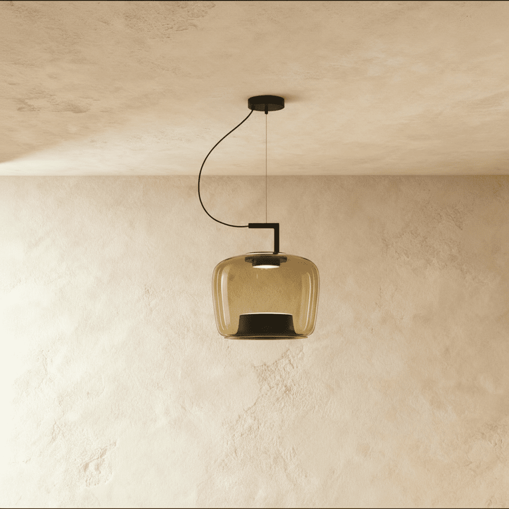 Clérachic mid-size pendant in amber glass, softly squared shade on a black arm and cord, lit against plaster.
