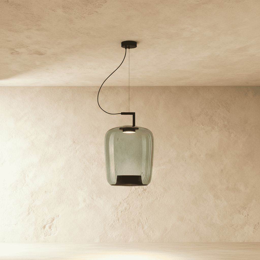 Clérachic tall pendant in green-tinted glass, an elongated shade with a black base cone, lit on a black arm.