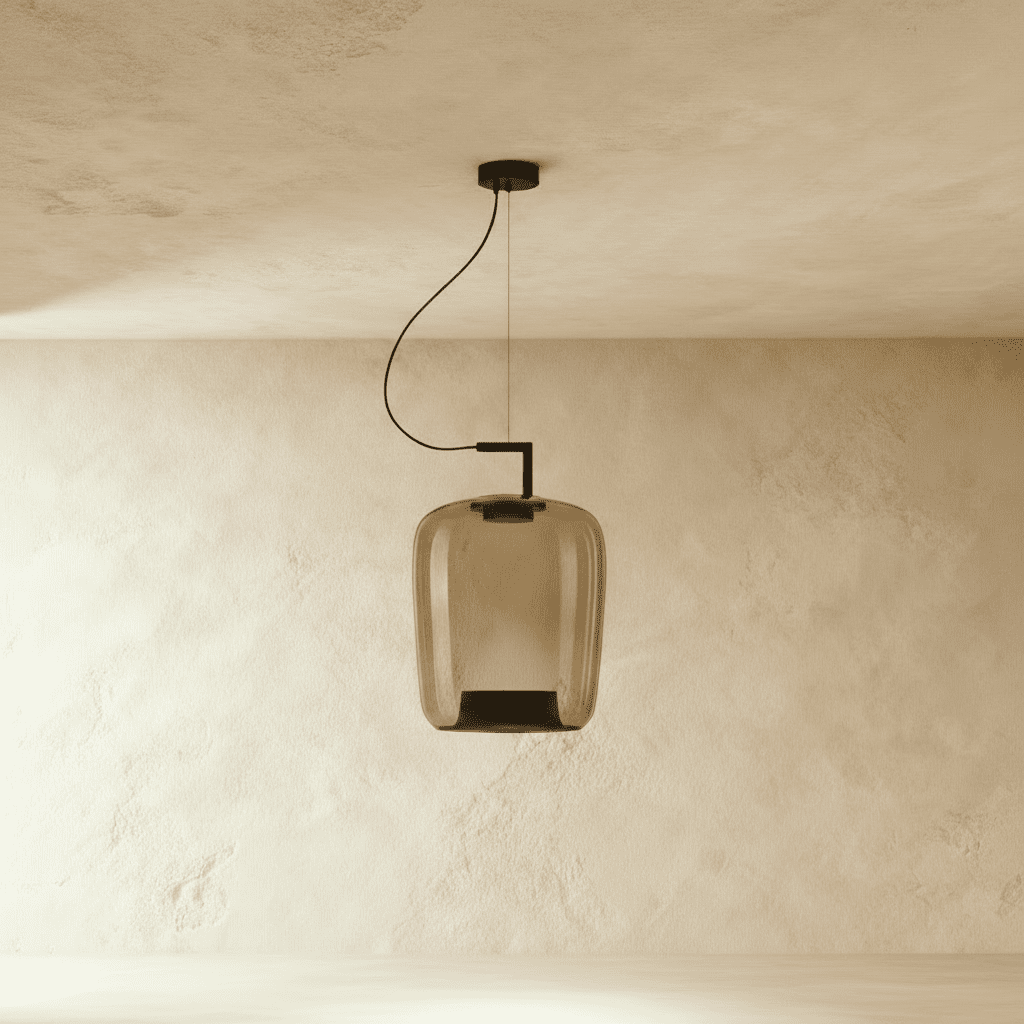Clérachic tall amber glass pendant, unlit, with a black inner cone, hanging from a black arm and cord.
