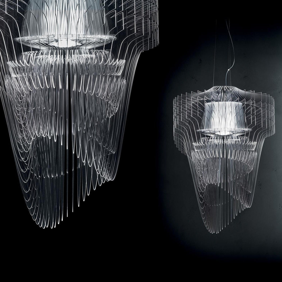 A large clear fringe pendant fills the left of the frame with a smaller one behind, both lit against a dark background from Clérachic.