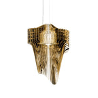 A Clérachic gold acrylic fringe pendant on three thin cables, its glossy fins layered round a pale inner shade, on white.