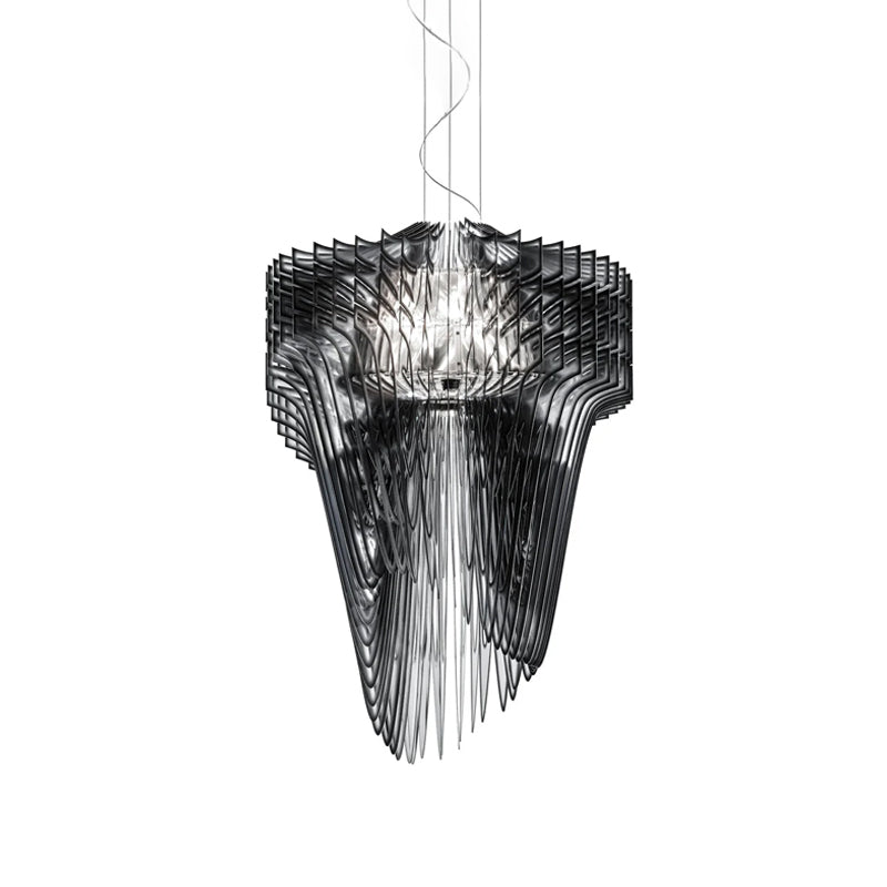 A Clérachic black acrylic fringe pendant on thin cables, its smoky fins stacked round a lit core, on a white backdrop.