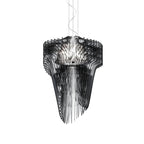 A Clérachic black acrylic fringe pendant on thin cables, its smoky fins stacked round a lit core, on a white backdrop.