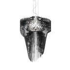 A Clérachic black fringe pendant on white, seen from slightly below with its dark fins falling in long, narrow strands.