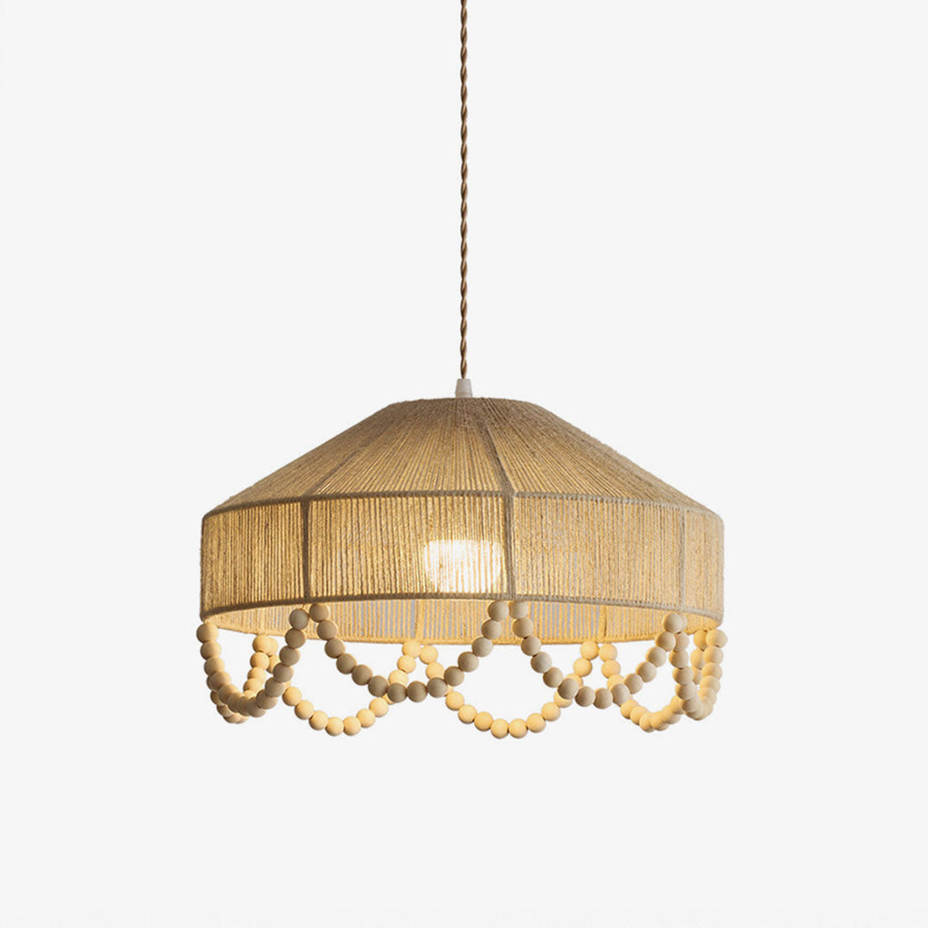 Studio shot of this Clérachic pendant's hemp rope drum shade and scalloped wood-bead fringe, on a plain backdrop.