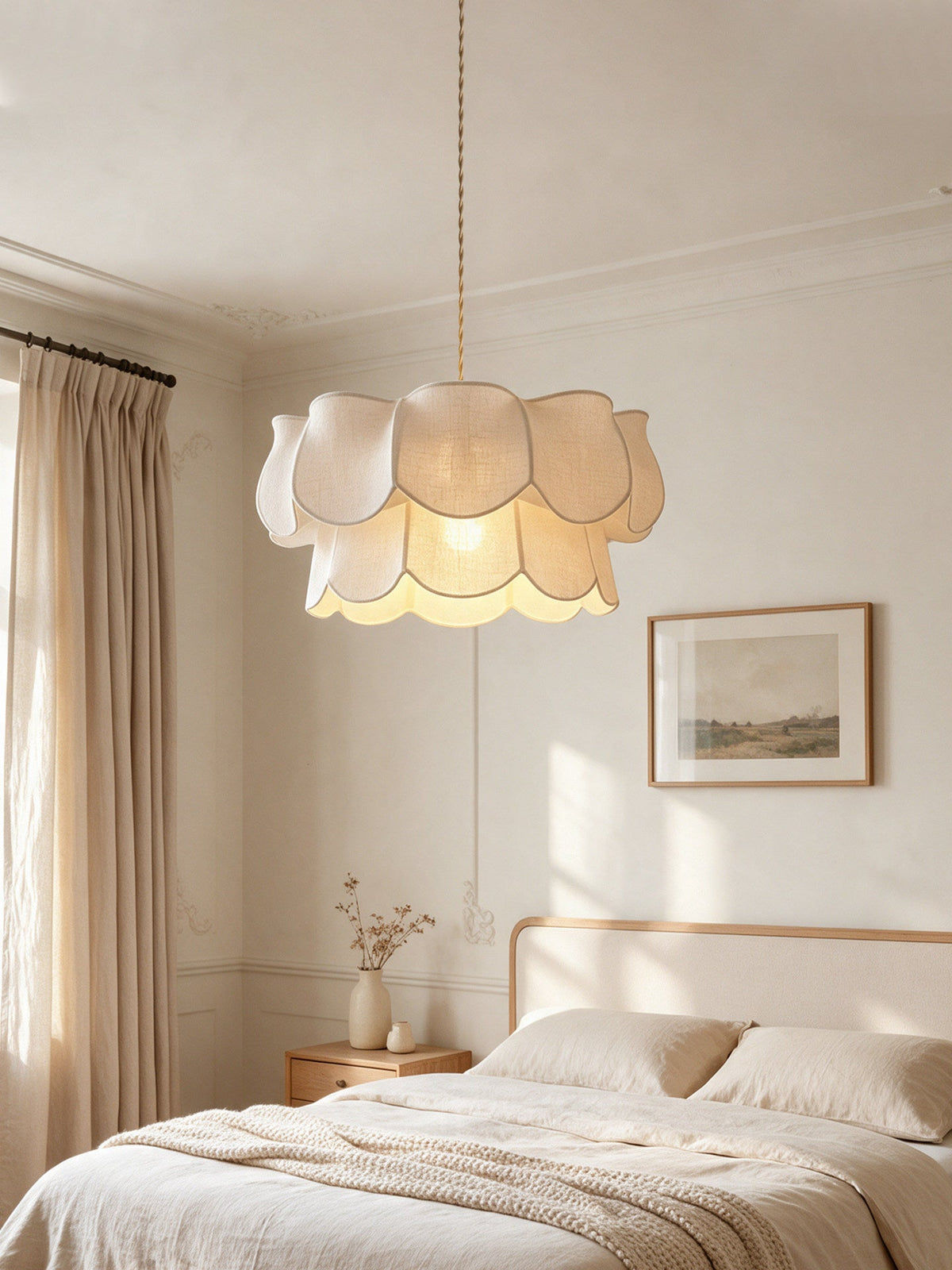 This Clérachic pendant, its linen petals layered in two tiers, hangs above a bed with panelled walls behind.