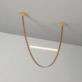 Single tan leather loop with a lit bar across it, hung from two brass canopy plates against a grey wall, on this Clérachic pendant.