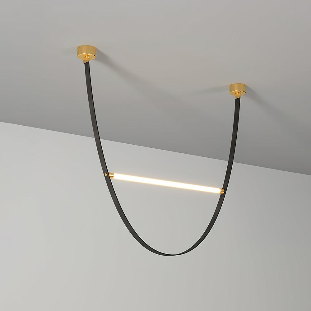 A black leather version of this Clérachic pendant, with two brass canopy plates and a single lit bar across the loop.