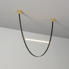 A black leather version of this Clérachic pendant, with two brass canopy plates and a single lit bar across the loop.