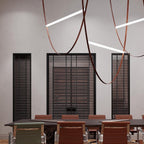 Leather loops and white light bars from this Clérachic pendant hang in a meeting room with dark slatted windows and a long table.