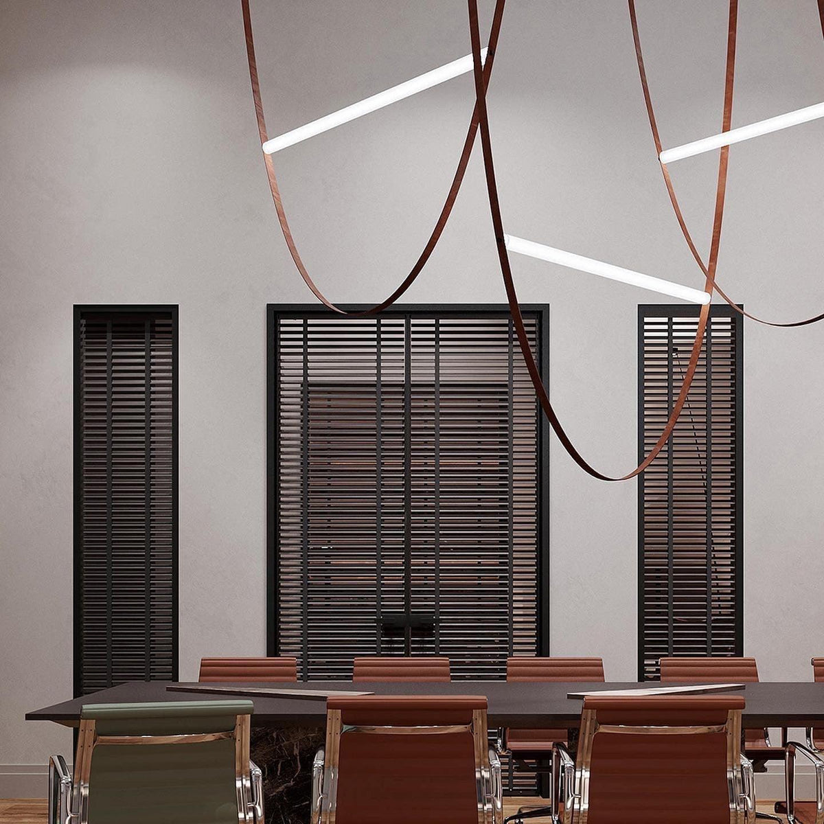 Leather loops and white light bars from this Clérachic pendant hang in a meeting room with dark slatted windows and a long table.