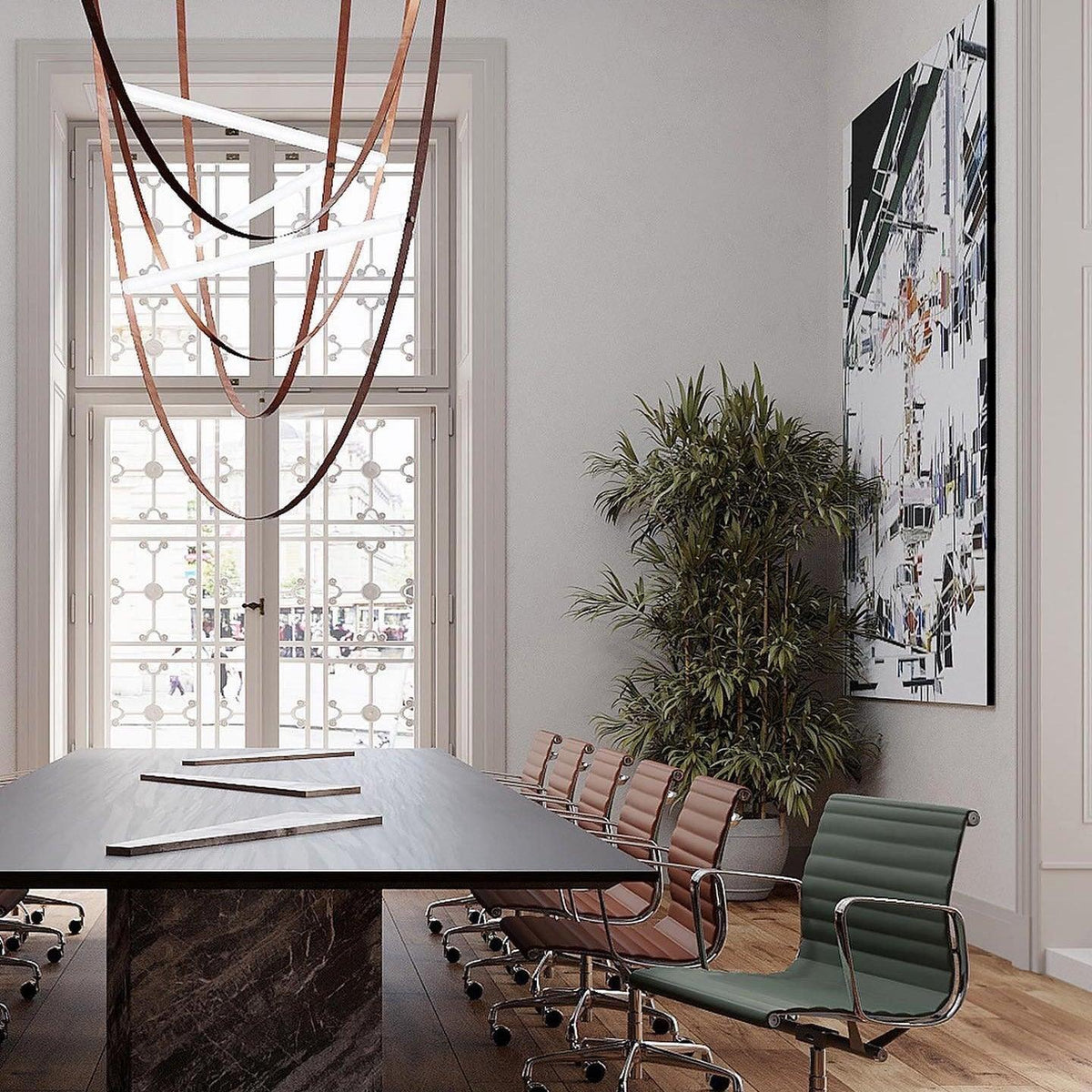 Looking up at the leather loops and glowing bars of this Clérachic pendant, with a dark table and green chair below.