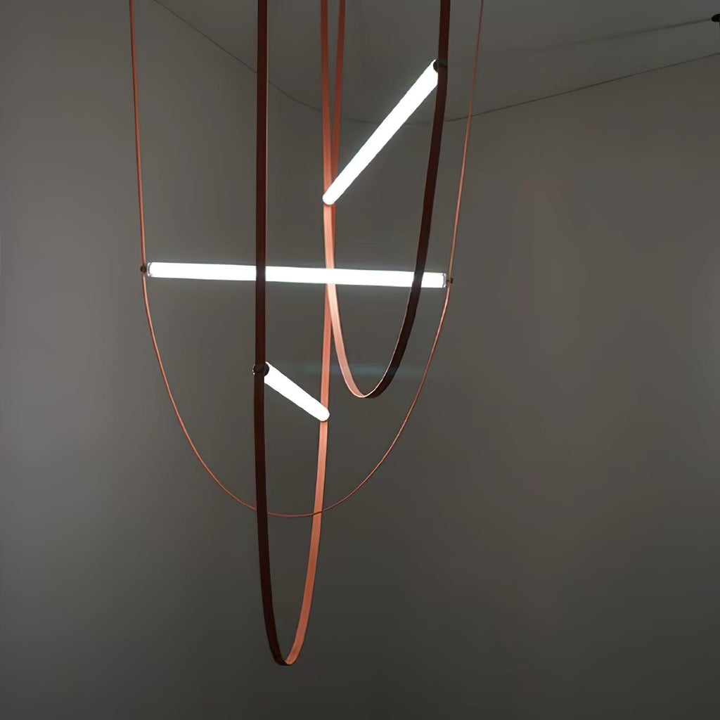 Three lit bars at different angles on leather loops, this Clérachic pendant seen against a dark grey wall.