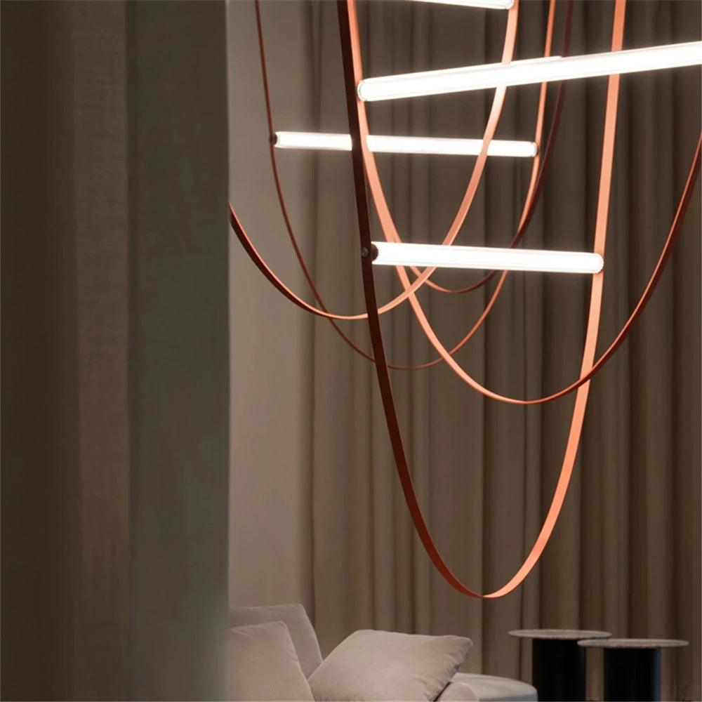 Dim, close view of leather loops sweeping past bright bars on this Clérachic pendant, with curtains and a sofa behind.