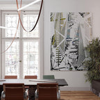 A Clérachic pendant with light bars on dark leather loops, hung beside a large window in a meeting room with a monochrome artwork.