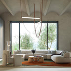 This Clérachic pendant hangs in a living room with a vaulted plaster ceiling and a big window onto olive trees.
