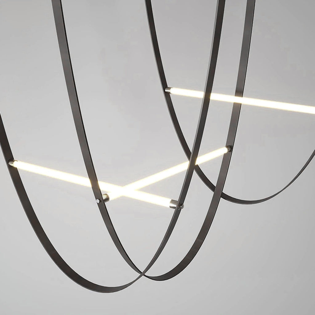 Close view of black leather loops and bars of this Clérachic pendant, seen from below against a grey background.