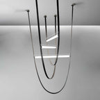 Render of this Clérachic pendant with dark leather loops, black canopy plates and three lit bars of different lengths on a grey backdrop.