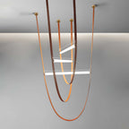 Render of this Clérachic pendant with copper-toned leather loops and brass canopies, three bars at different heights, on grey.