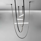 Three black leather loops with black canopies and lit bars of different lengths, rendered on a grey backdrop for this Clérachic pendant.