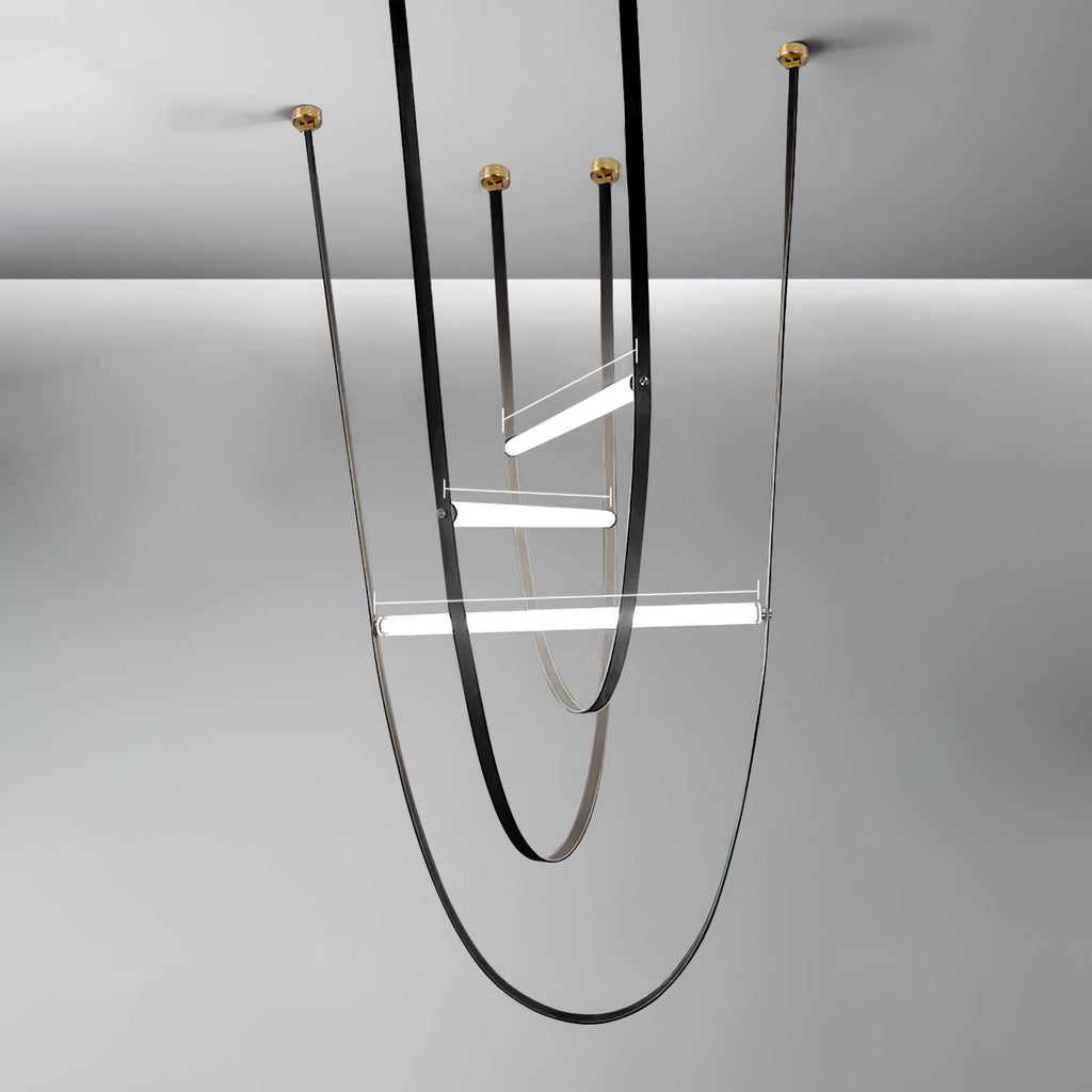 Three-loop render of this Clérachic pendant in black leather with brass canopy plates on a grey backdrop.