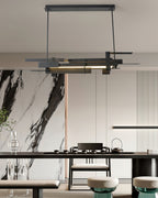 A black linear Clérachic pendant hangs in front of a marble-effect wall above a dark dining table with a tea set.
