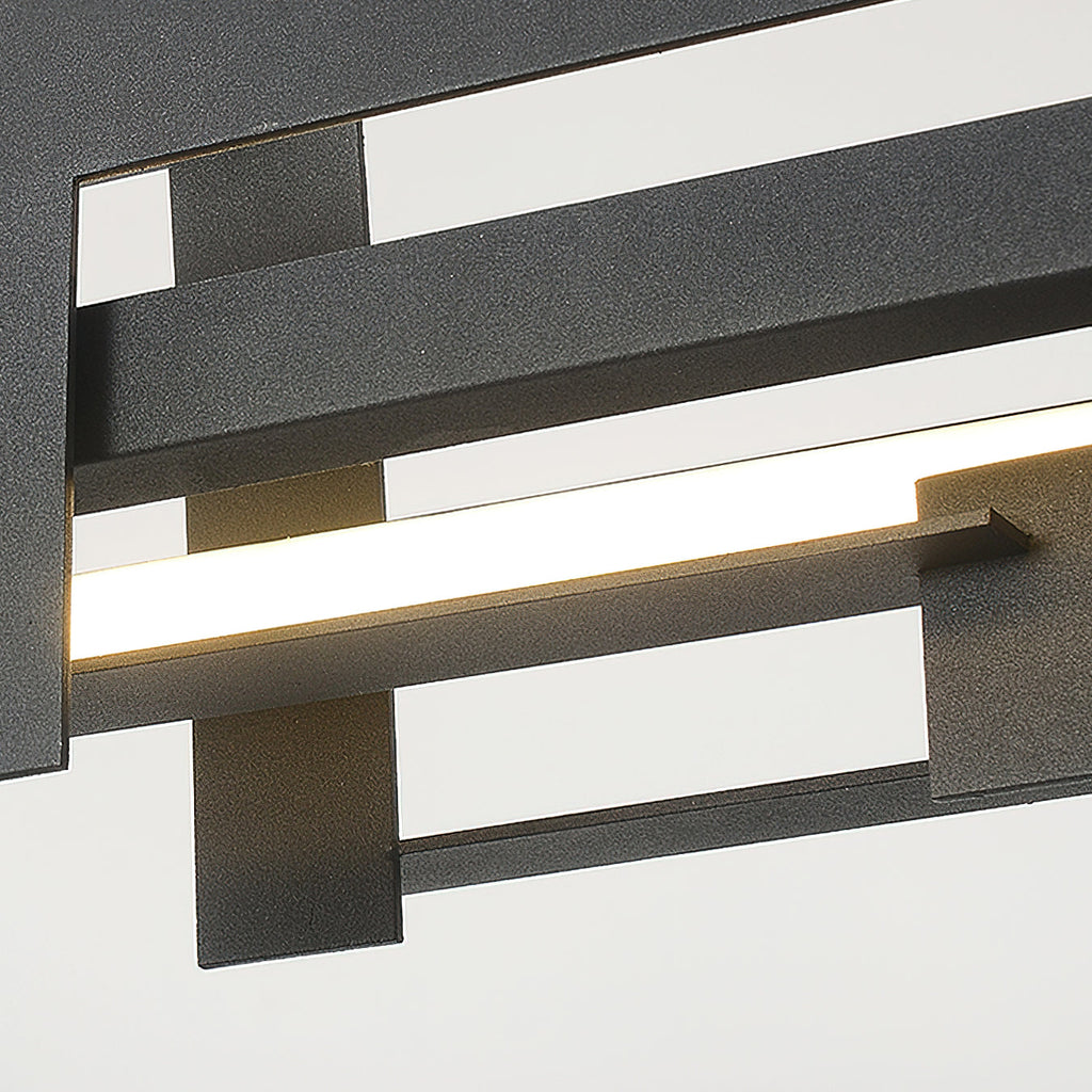 Close view of the matte black bars of this Clérachic pendant, with a bright, even LED strip glowing between the layered metal plates.
