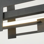 Close view of the matte black bars of this Clérachic pendant, with a bright, even LED strip glowing between the layered metal plates.