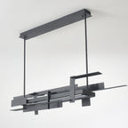 Unlit, a long matte black Clérachic pendant shows its stacked flat bars, two hanging rods and a rectangular ceiling bar on a pale backdrop.