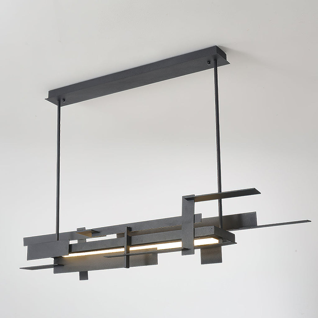 A long matte black Clérachic pendant lit along its lower bar and hung from a ceiling bar, on a pale backdrop.