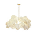 Cream-white feathers layer into a soft bowl shape on this Clérachic chandelier, hung from a brass stem on white.