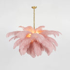 Soft pink plumes with a warm glow at the centre, on a Clérachic chandelier with a brass stem and ceiling cup.