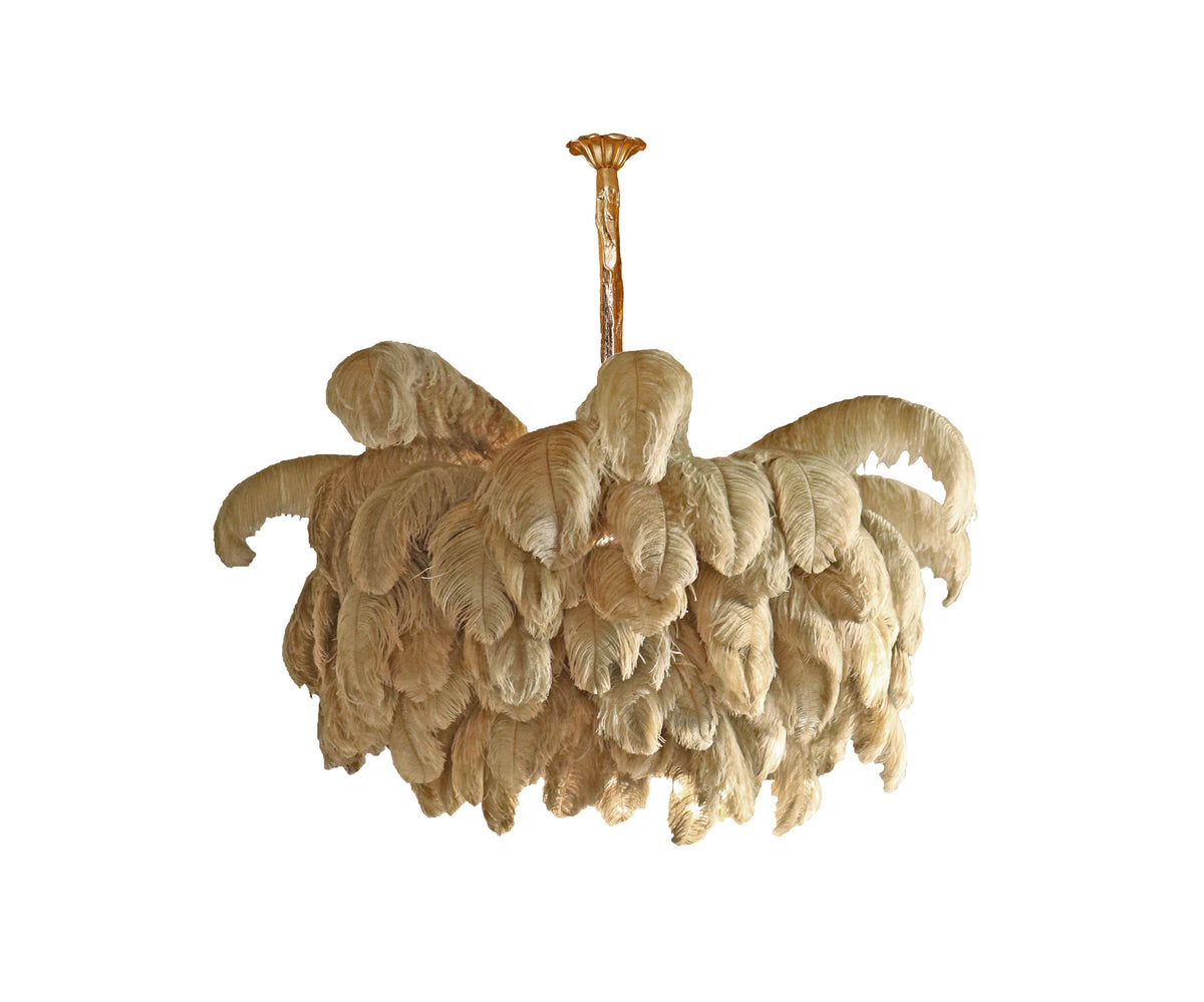 Natural feathers in a sandy tone on a small Clérachic chandelier, seen from slightly below on white.