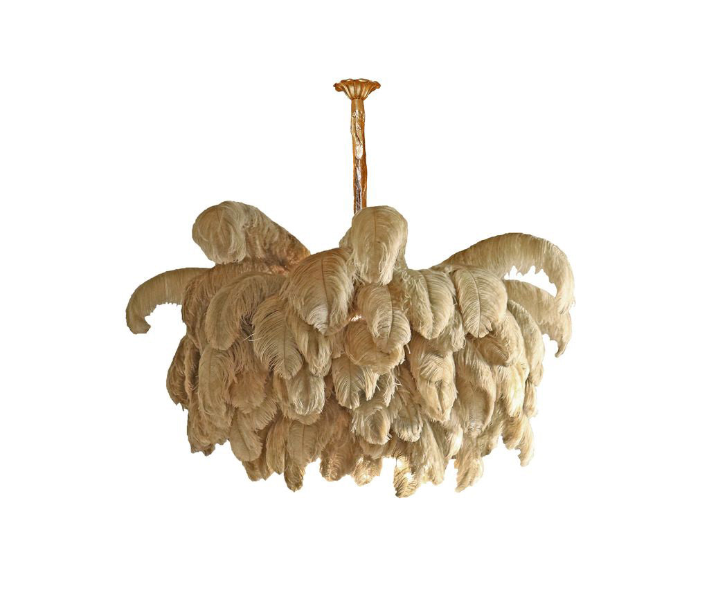 A compact Clérachic chandelier in natural sandy feathers hangs from a thin brass stem on a plain white background.