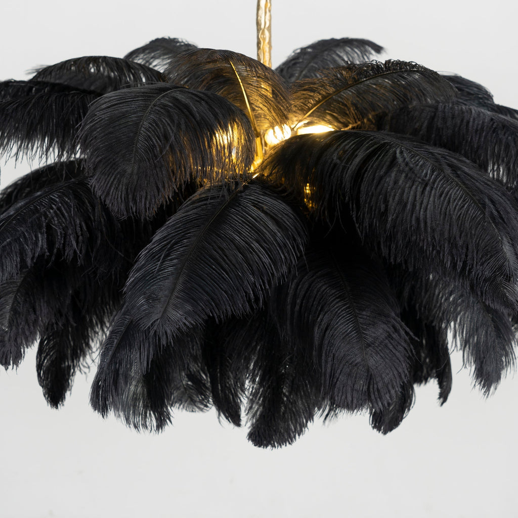 Another close crop of this Clérachic chandelier, black plumes layered thick around a glowing centre.