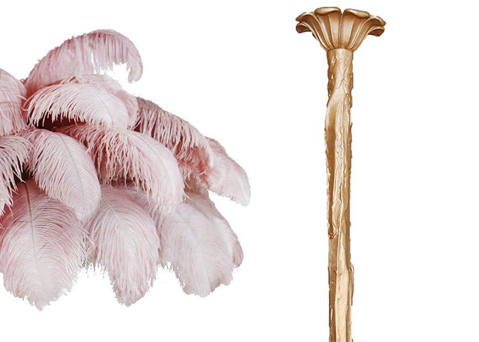 Swatch of pale pink ostrich feathers beside the brass-finish stem and ceiling cup of this Clérachic chandelier.