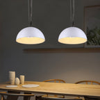 Two Clérachic white dome pendant lights hung side by side over a pale wood dining table in a grey room.
